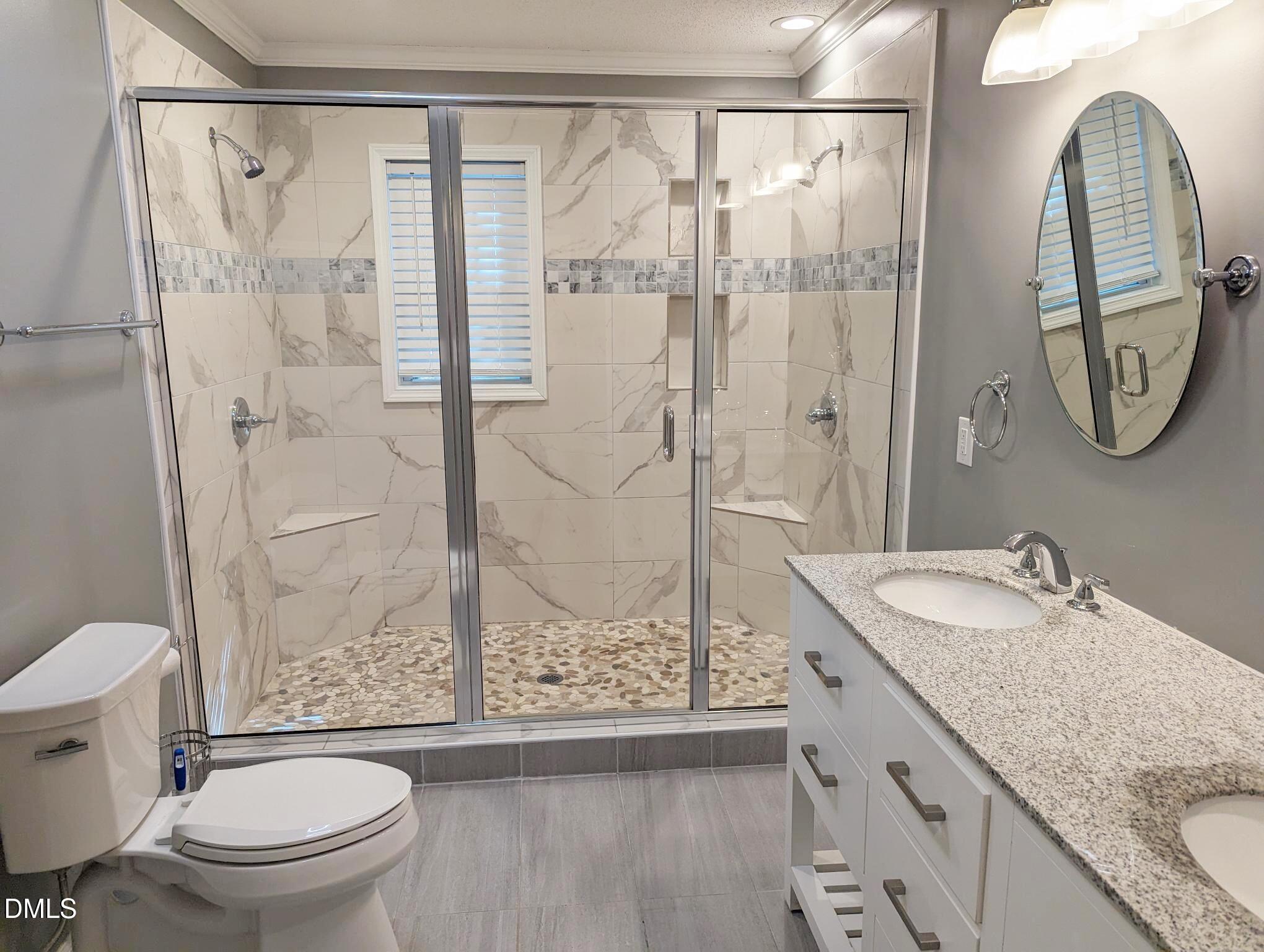 7416 Ray Road Raleigh, NC 27613 - Photo 10 of 12 a bathroom with a granite countertop sink toilet and shower