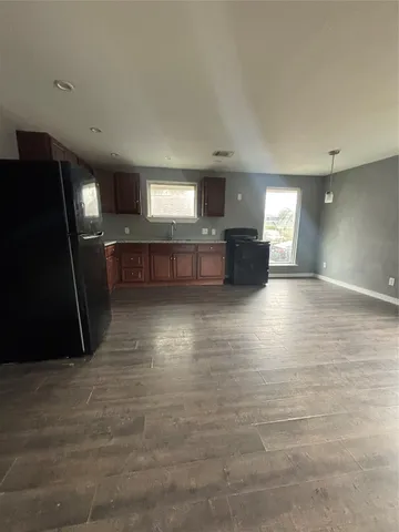 a view of a living room a kitchen with a sink