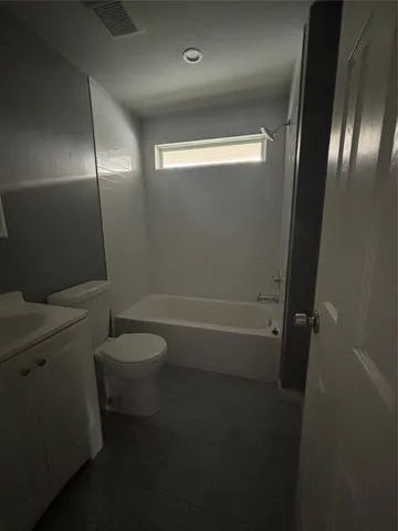 a bathroom with a toilet a sink and shower
