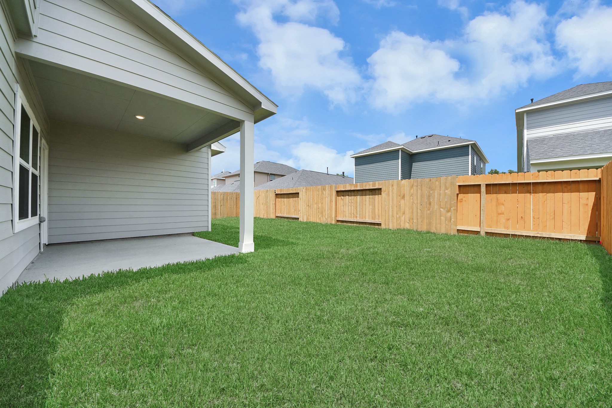 15523 Fathom Line Way Houston, TX 77053 - Photo 32 of 39 Spacious backyard with a well-maintained lawn, enclosed by a wooden fence, perfect for outdoor activities and privacy.