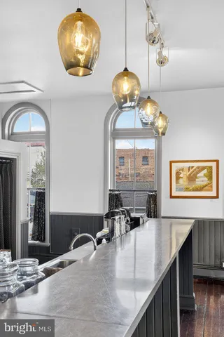 a kitchen with a sink appliances and cabinets
