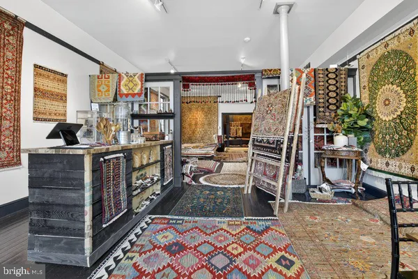 a room with lots of wooden furniture and windows