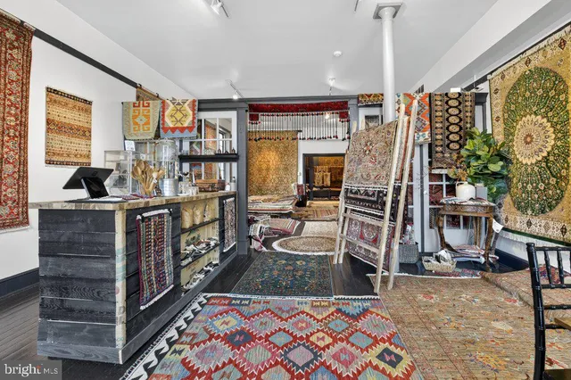 a room with lots of wooden furniture and windows