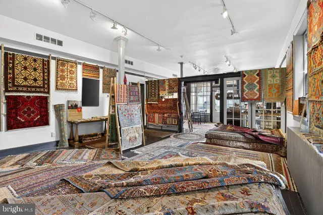 a living room with furniture and a rug
