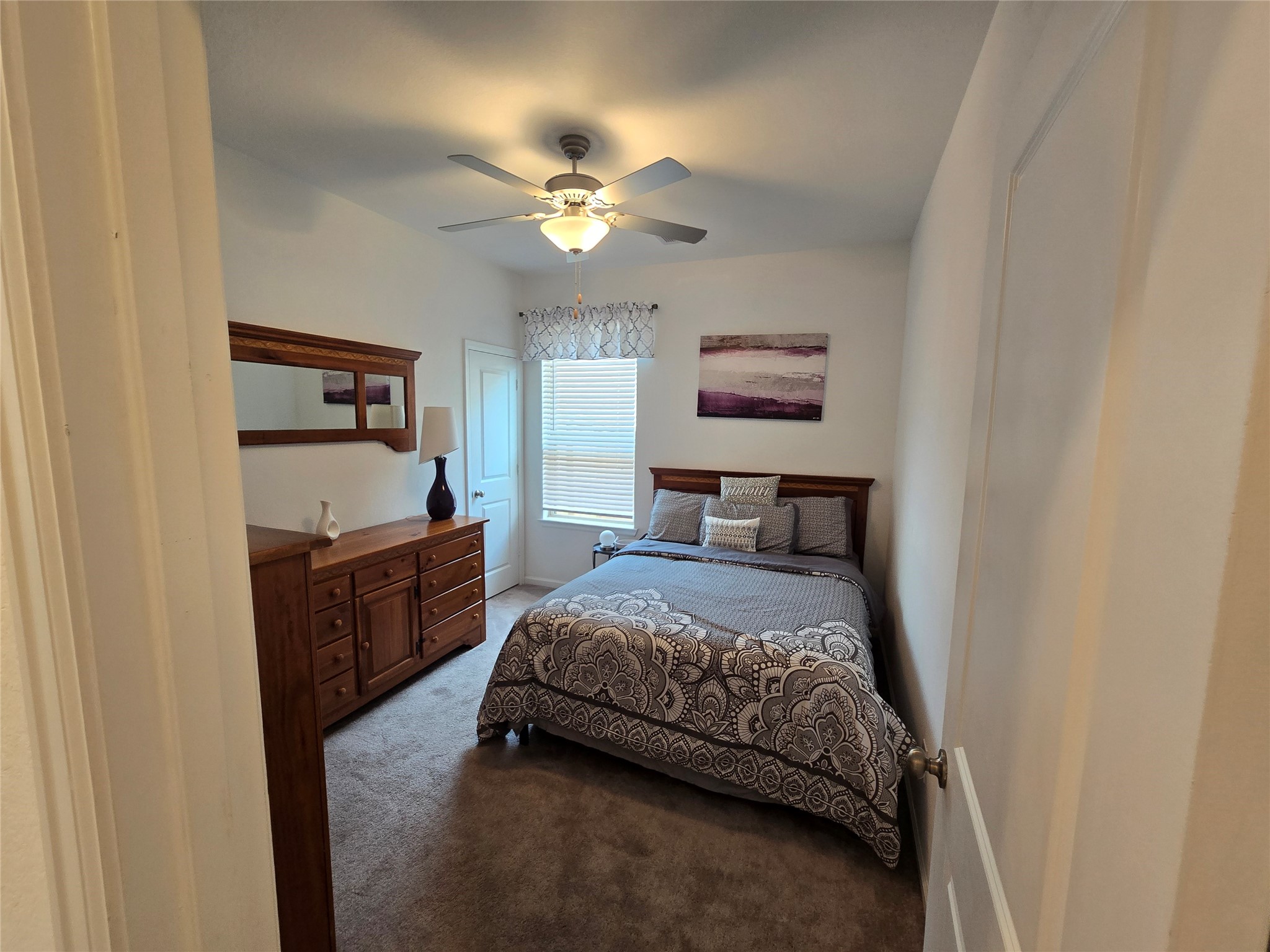 5035 Sierra Ridge Drive Rosenberg, TX 77469 - Photo 16 of 26 Inviting guest bedroom with ample natural light, cozy ambiance, and elegant furnishings.