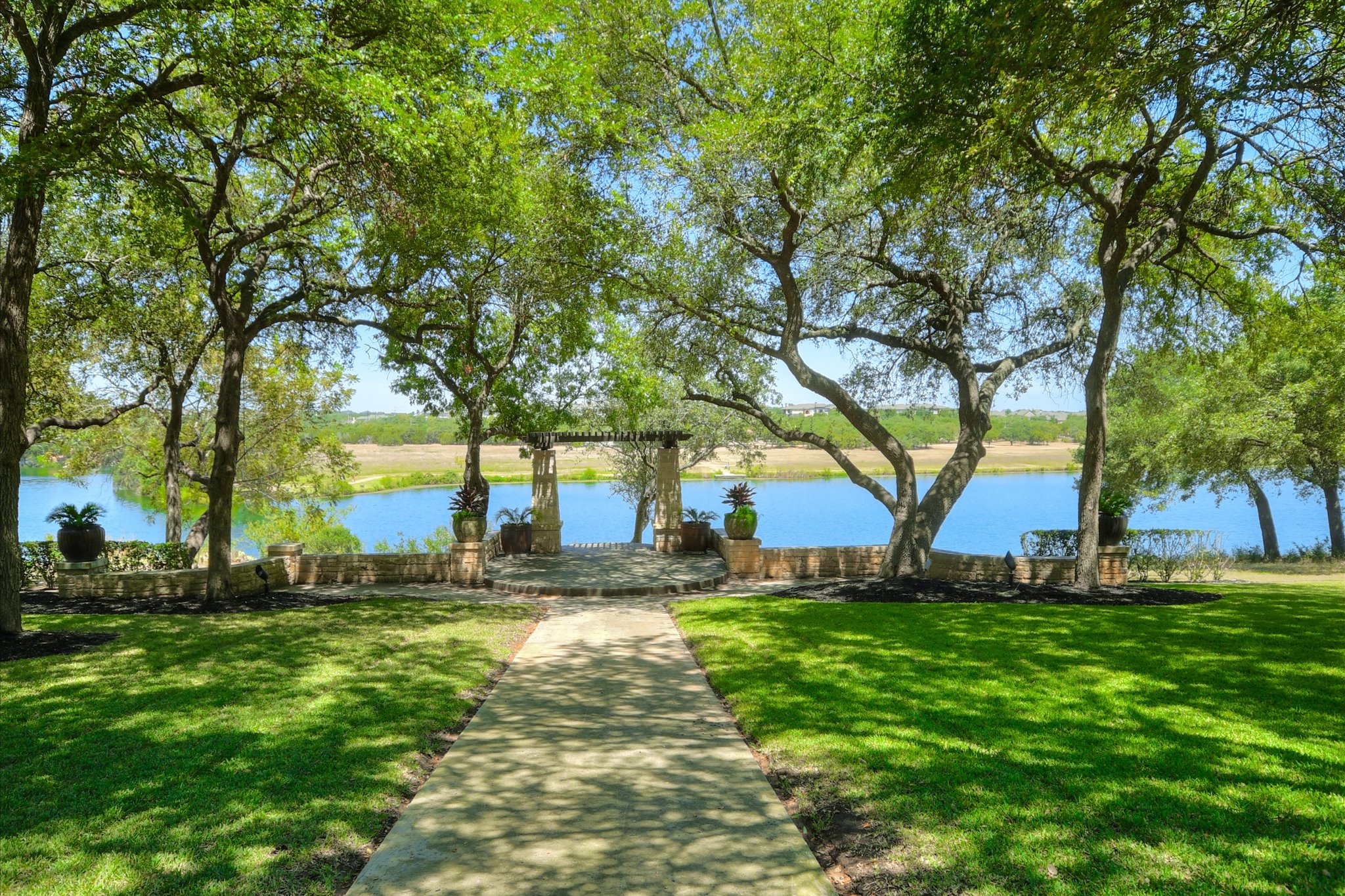 14001 Avery Ranch Boulevard, Unit 202 Austin, TX 78717 - Photo 22 of 30 Manicured lawn with a stone pathway leading to a terraced stone patio