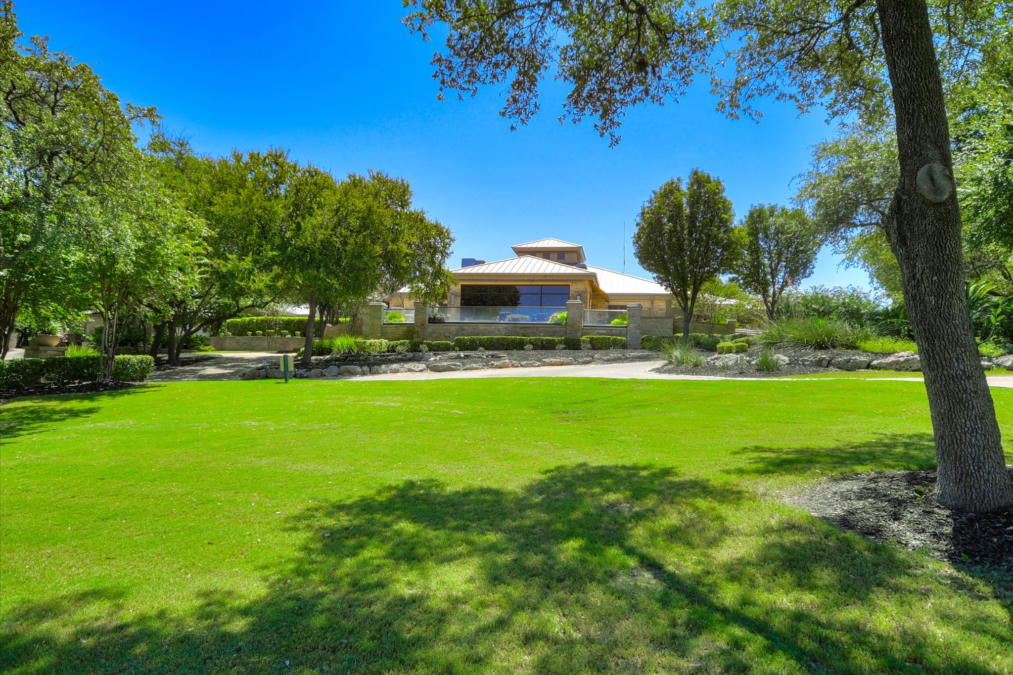 14001 Avery Ranch Boulevard, Unit 202 Austin, TX 78717 - Photo 23 of 30 Expansive green lawn framed by mature trees