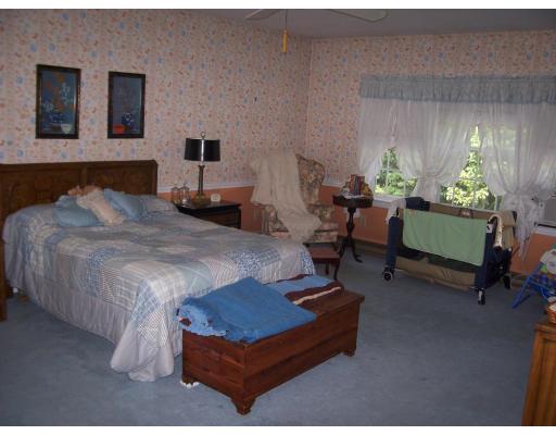 7 Washington Terrace Woburn, MA 01801 - Photo 12 of 16 a bedroom with a bed a table and a couch