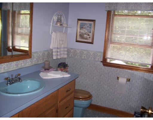 7 Washington Terrace Woburn, MA 01801 - Photo 15 of 16 a bathroom with a sink a toilet and mirror