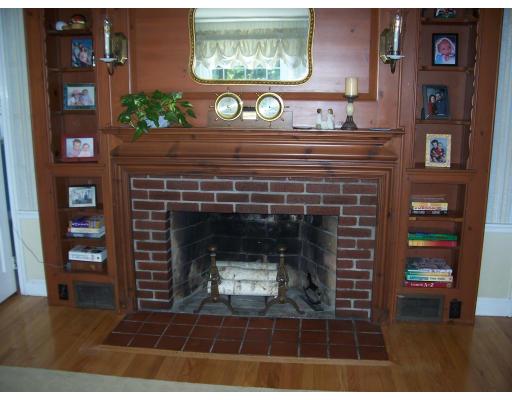 7 Washington Terrace Woburn, MA 01801 - Photo 10 of 16 a closeup of a fireplace with a book shelf