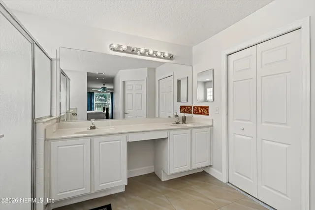 a living room with furniture a mirror a clock and a window