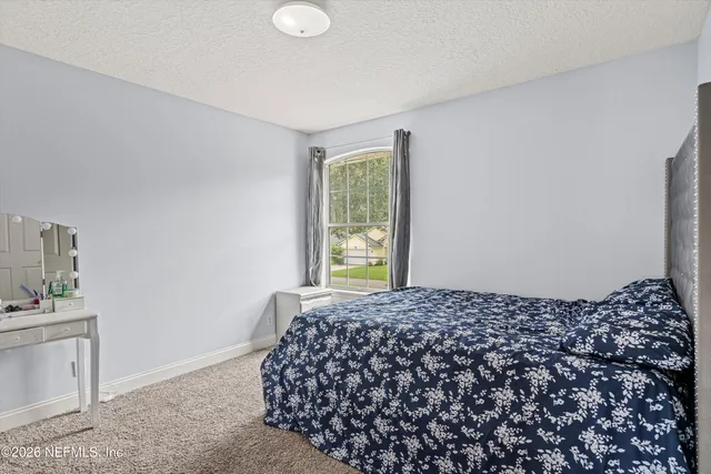 a view of a house with a yard and porch