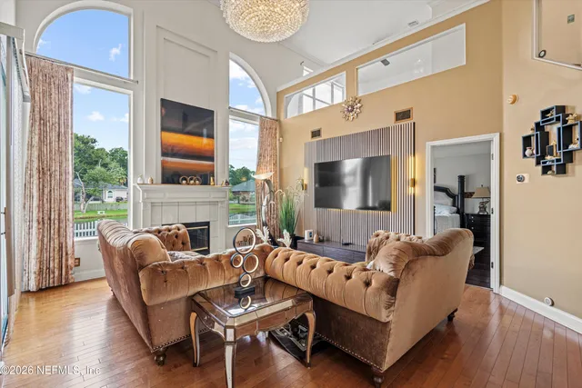 a living room with furniture a couch and a window