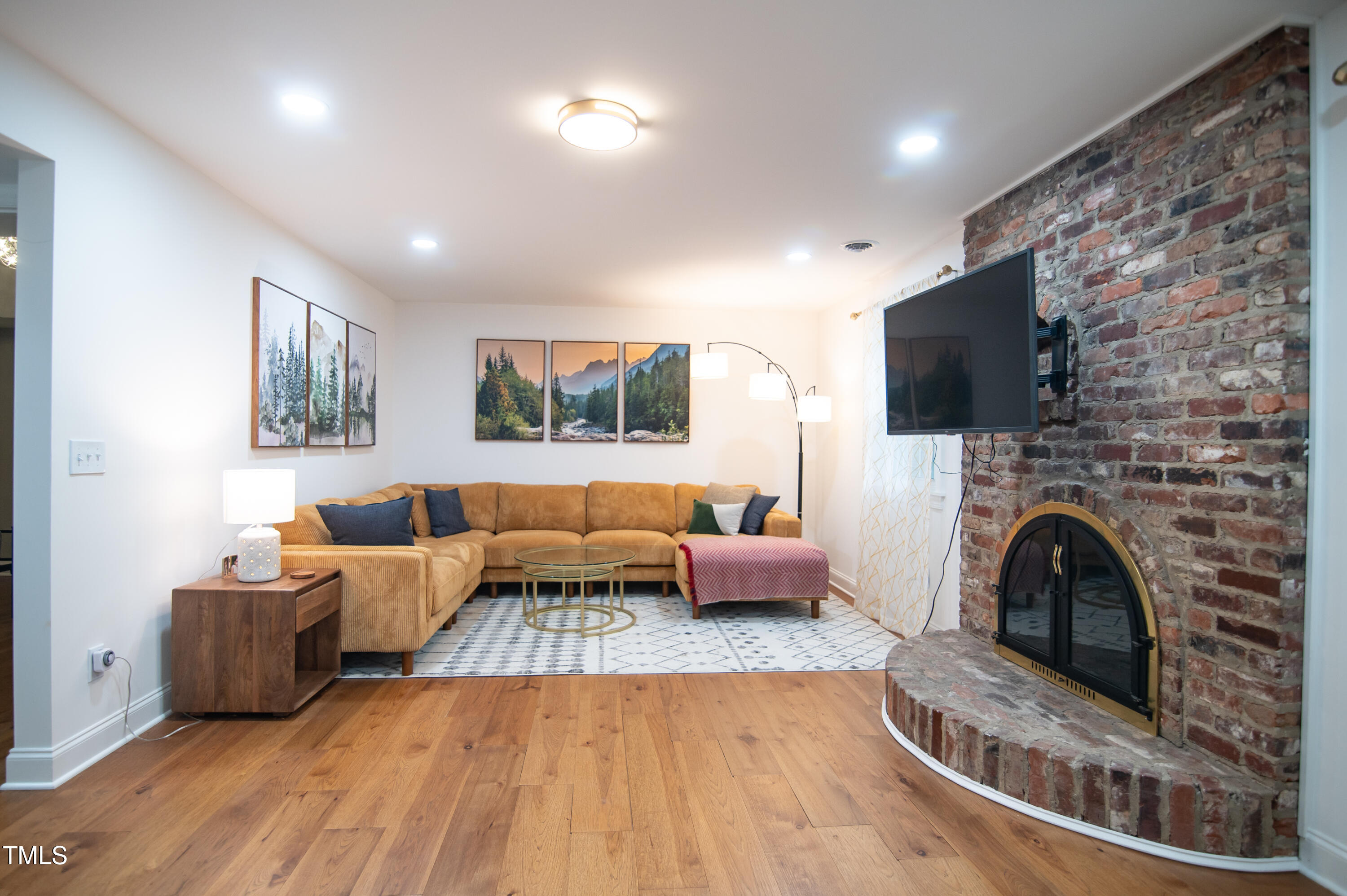 5012 Skidmore Street Raleigh, NC 27609 - Photo 10 of 27 a living room with furniture and a flat screen tv
