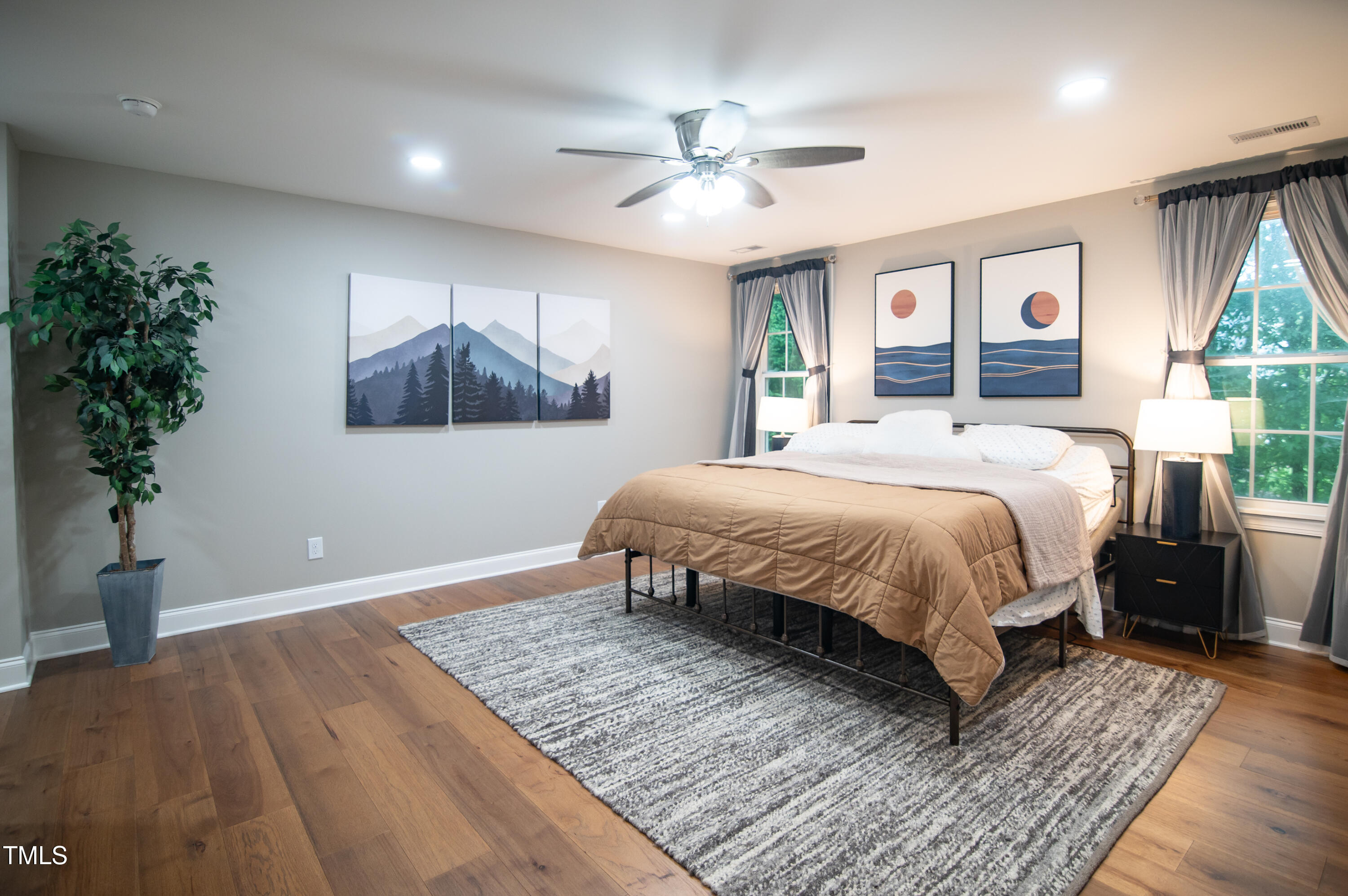 5012 Skidmore Street Raleigh, NC 27609 - Photo 13 of 27 a bedroom with a large bed and a chandelier