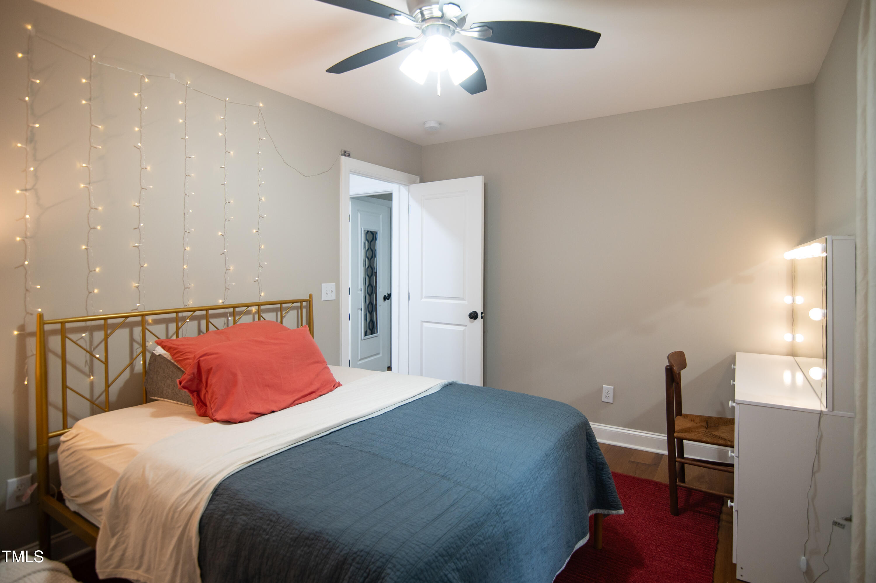5012 Skidmore Street Raleigh, NC 27609 - Photo 17 of 27 a bedroom with a bed and a chandelier