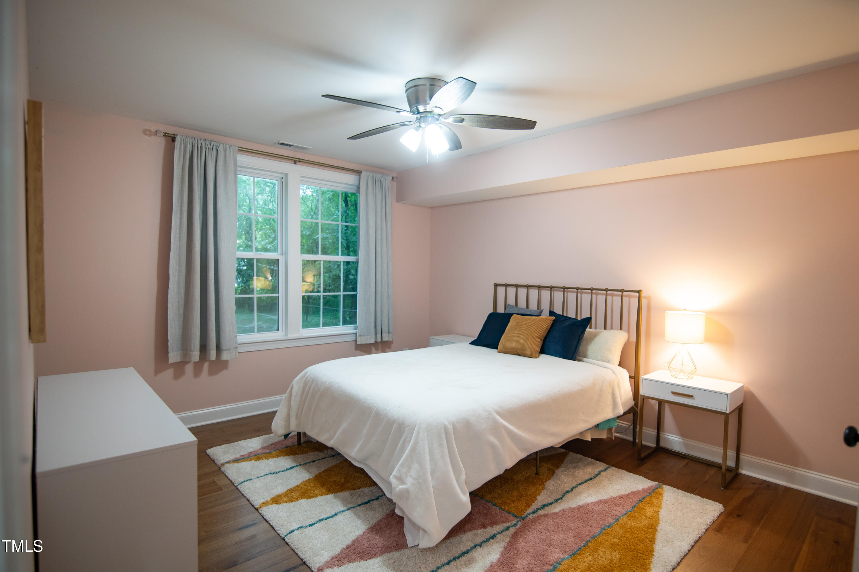 5012 Skidmore Street Raleigh, NC 27609 - Photo 19 of 27 a bedroom with a bed and a chandelier