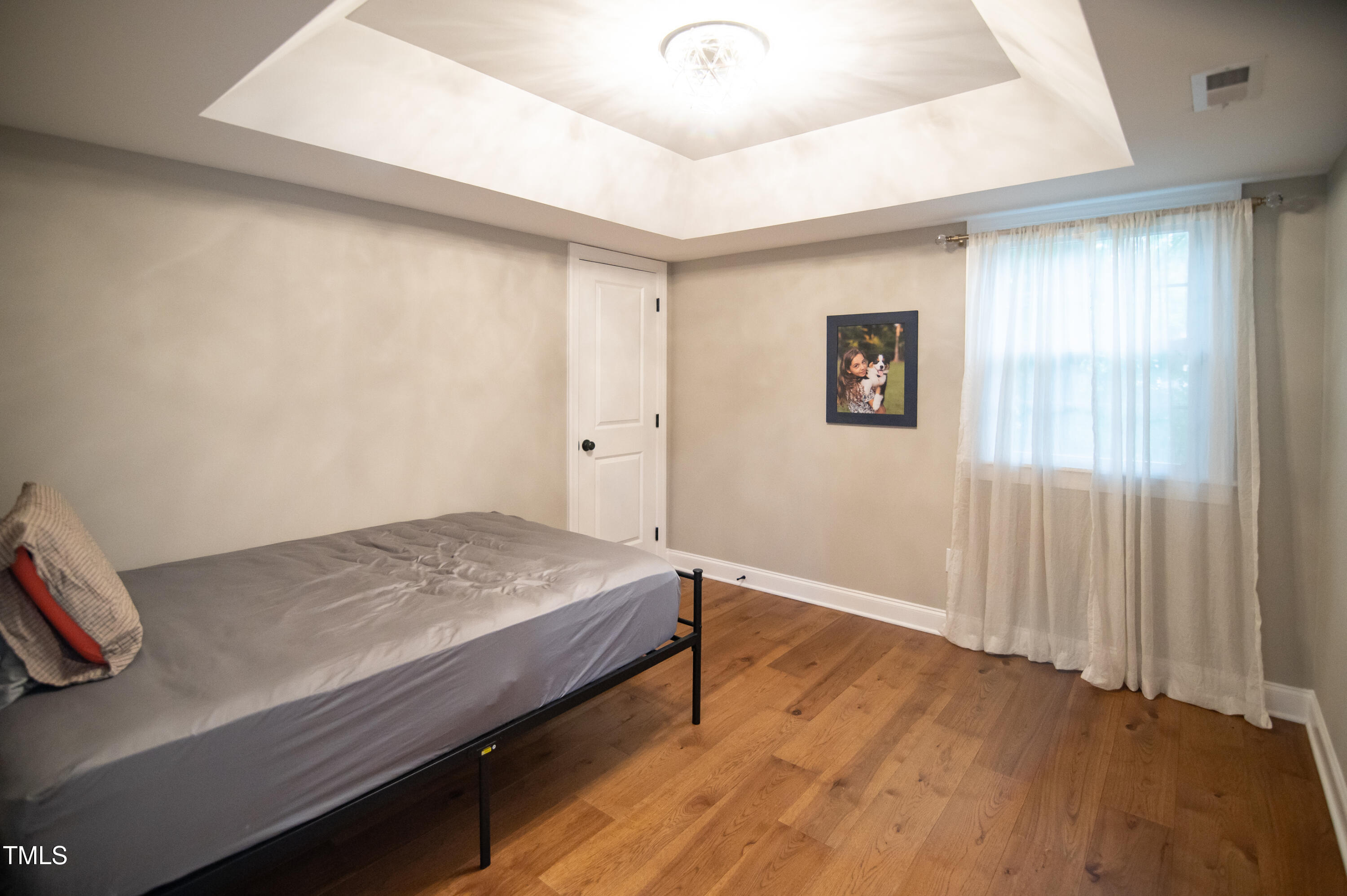 5012 Skidmore Street Raleigh, NC 27609 - Photo 20 of 27 a bedroom with a bed and a window