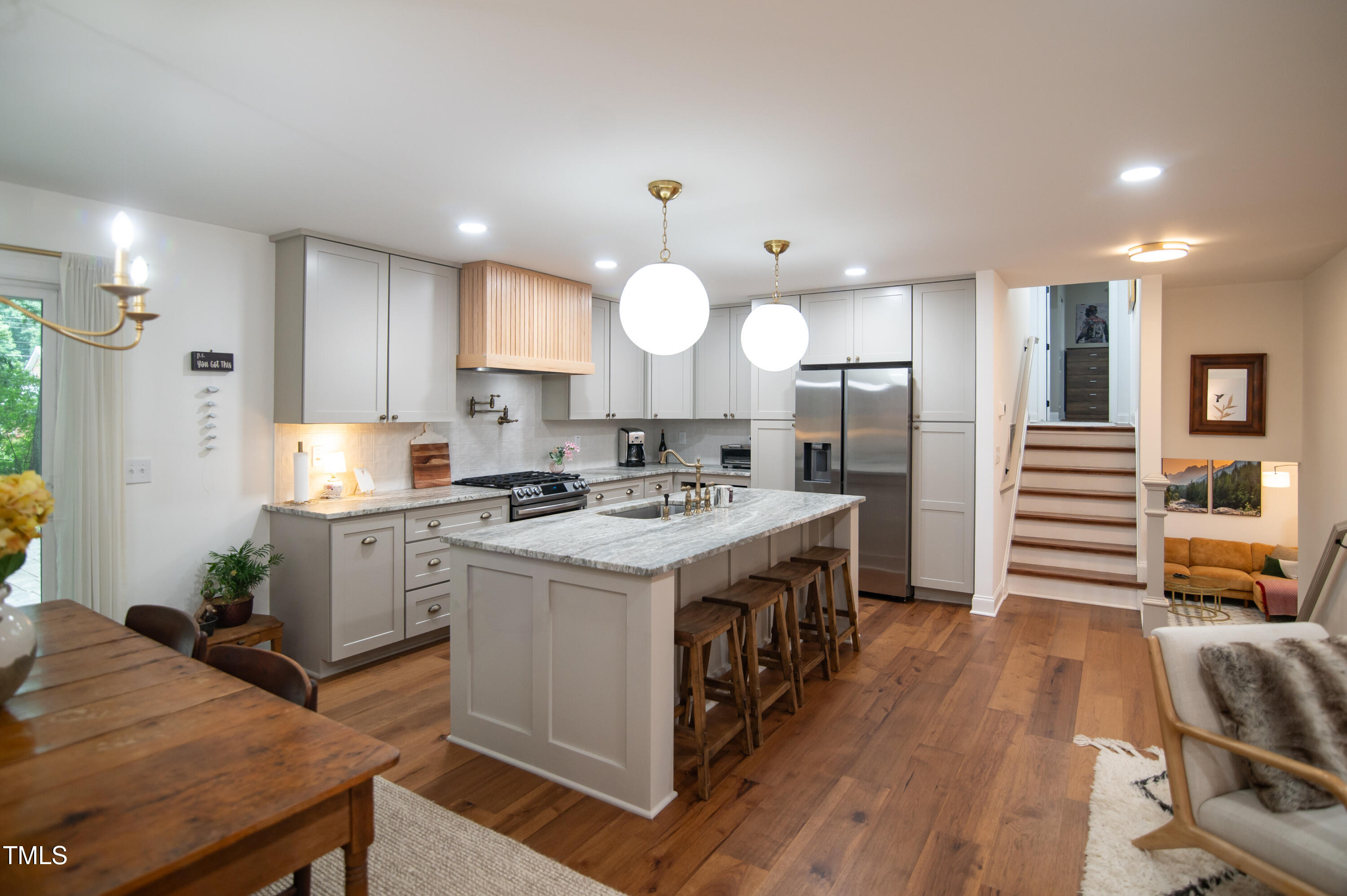 5012 Skidmore Street Raleigh, NC 27609 - Photo 3 of 27 a kitchen with a stove a refrigerator and wooden floor