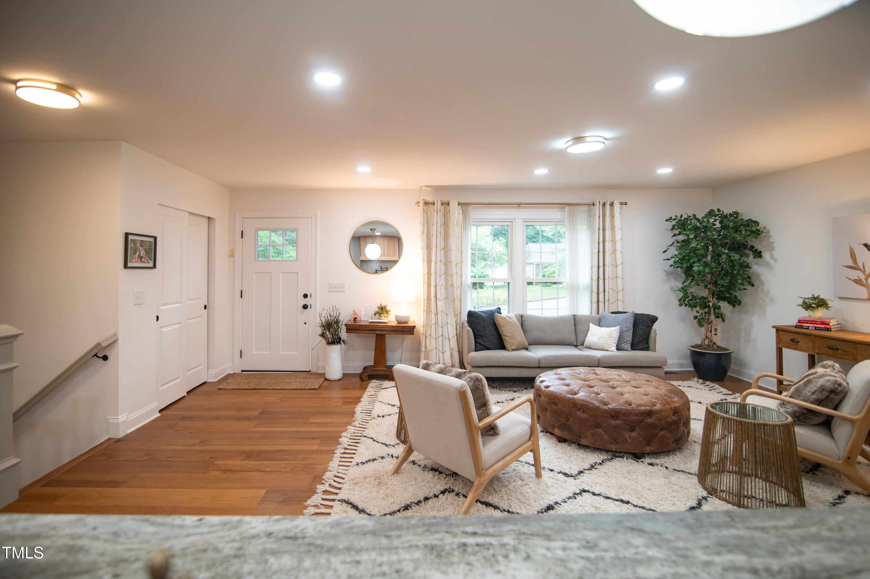 5012 Skidmore Street Raleigh, NC 27609 - Photo 9 of 27 a living room with furniture and a large window