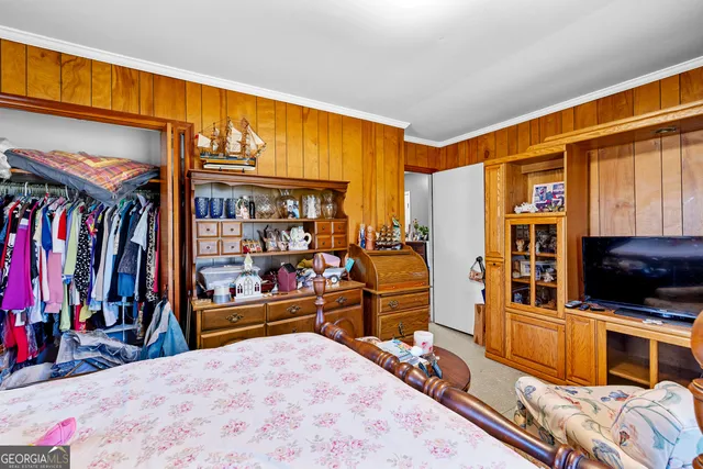 a view of a living room with a large bed and a large window