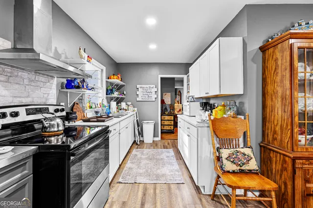 a kitchen with stainless steel appliances granite countertop a refrigerator a stove top oven a sink and dishwasher