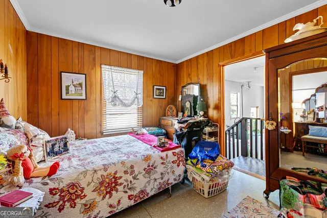 a bedroom with bed and wooden floor