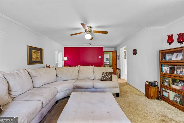 a dining room with furniture and wooden floor