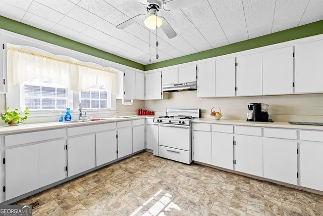 a view of a kitchen with furniture and a window