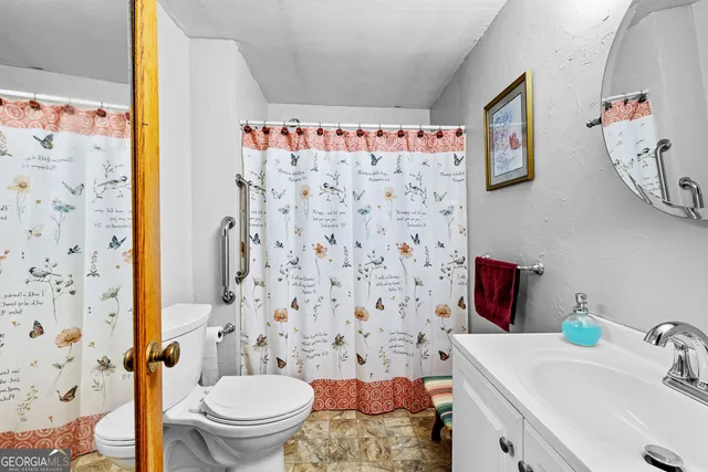 a view of a livingroom with furniture and a flat screen tv