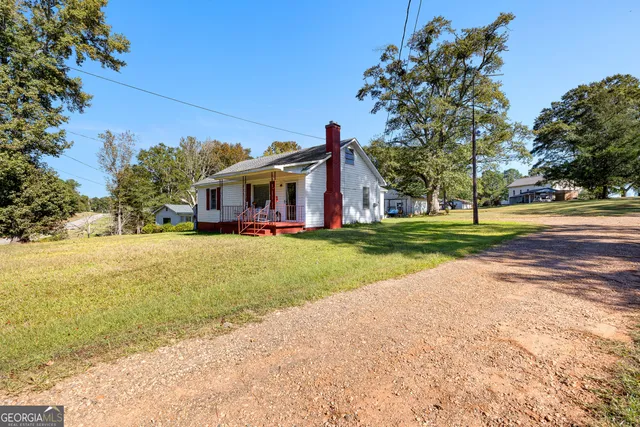 a view of house with outdoor space and garden