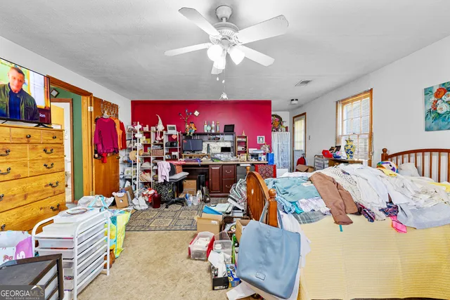 a living room with furniture a window and a kitchen view