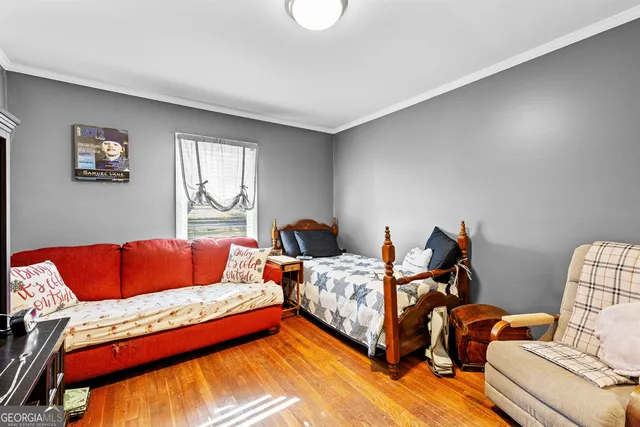 a bedroom with two beds and a couch