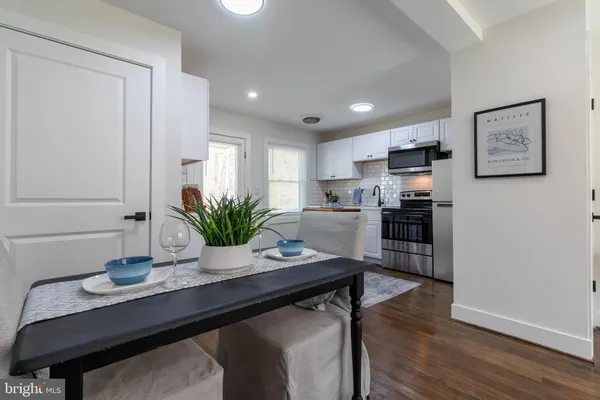 a kitchen with a table and chairs in it