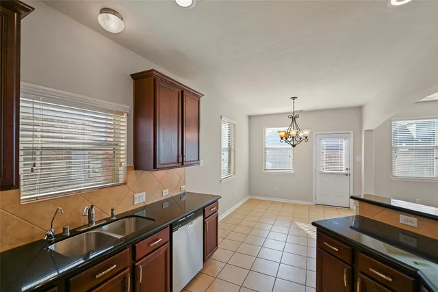 a kitchen that has a sink and a stove