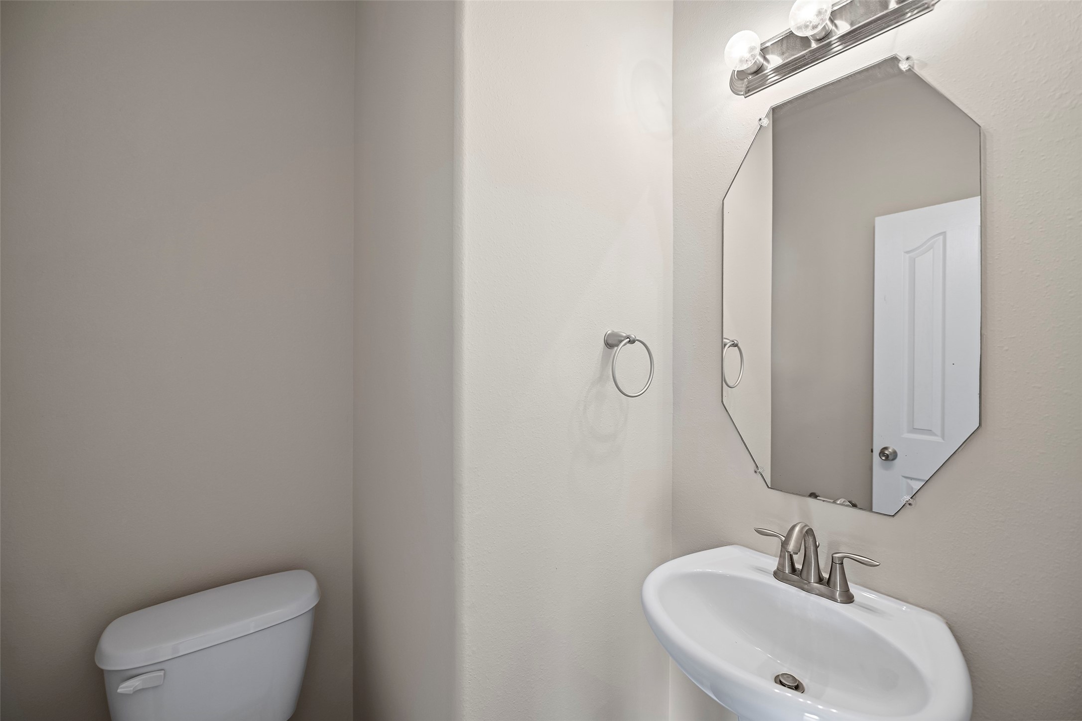 8323 Rudy Brook Way Spring, TX 77379 - Photo 14 of 35 a bathroom with a toilet a sink and mirror