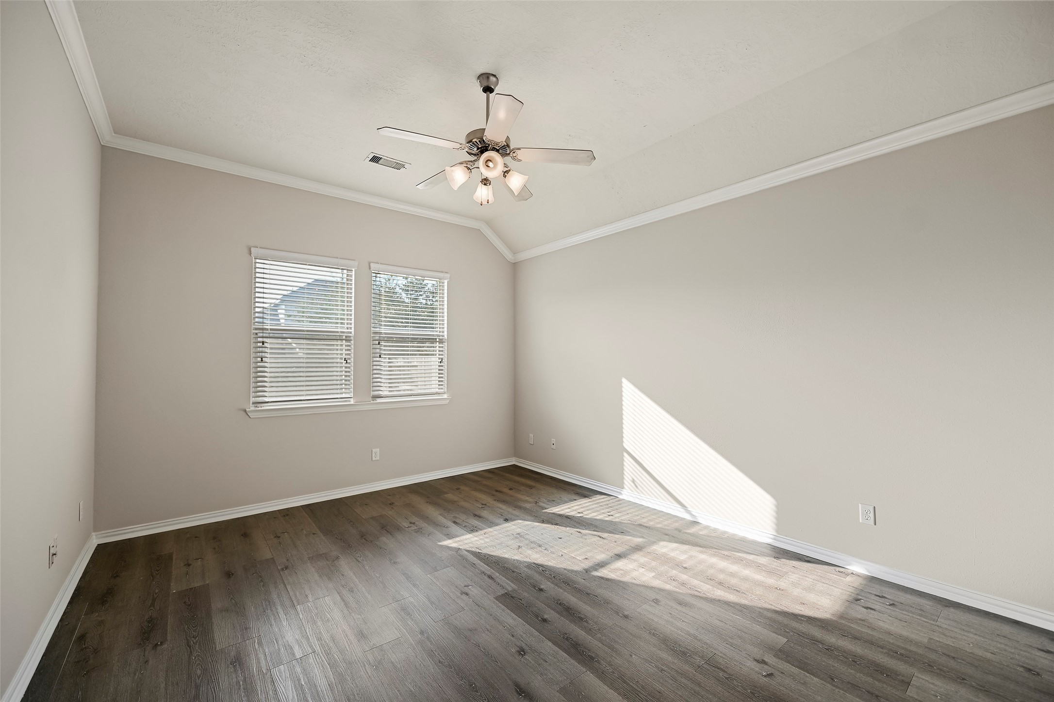8323 Rudy Brook Way Spring, TX 77379 - Photo 15 of 35 an empty room with wooden floor chandelier fan and windows