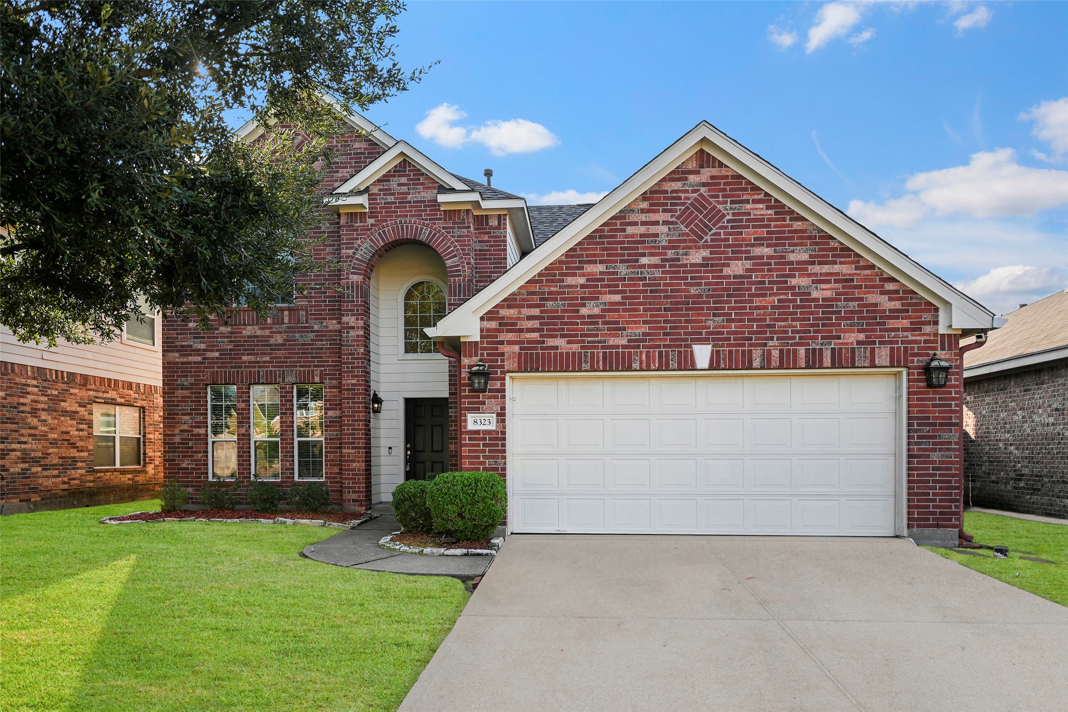 8323 Rudy Brook Way Spring, TX 77379 - Photo 2 of 35 a front view of a house with a yard and garage