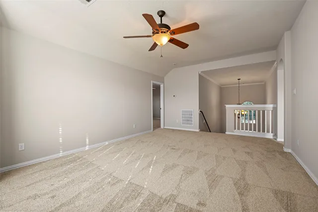 a view of empty room with ceiling fan