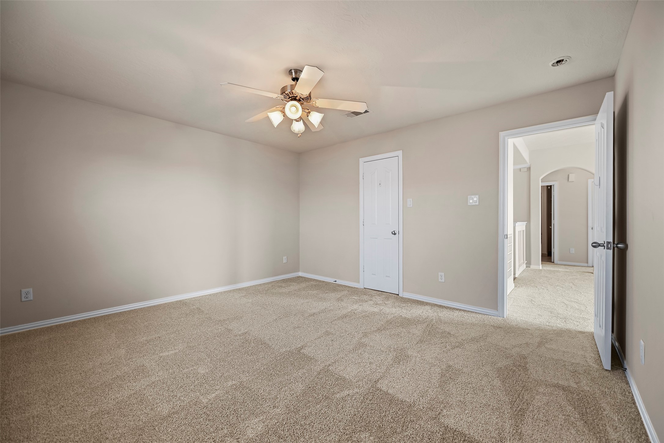 8323 Rudy Brook Way Spring, TX 77379 - Photo 26 of 35 an empty room with chandelier fan and windows
