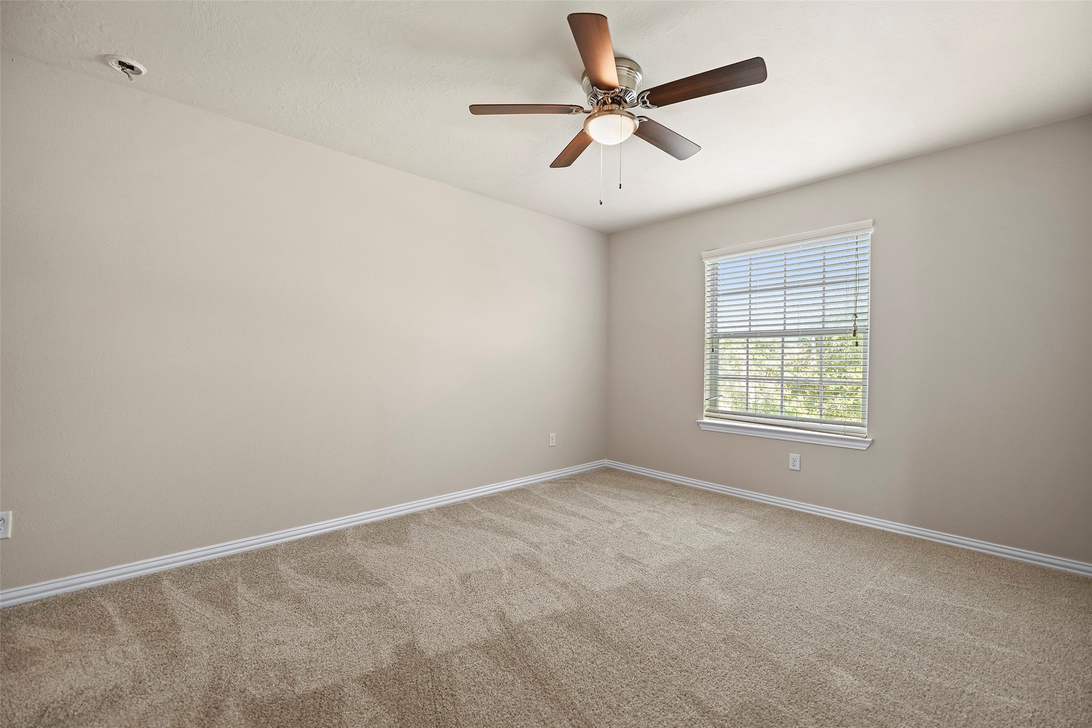 8323 Rudy Brook Way Spring, TX 77379 - Photo 29 of 35 an empty room with a window and a fan
