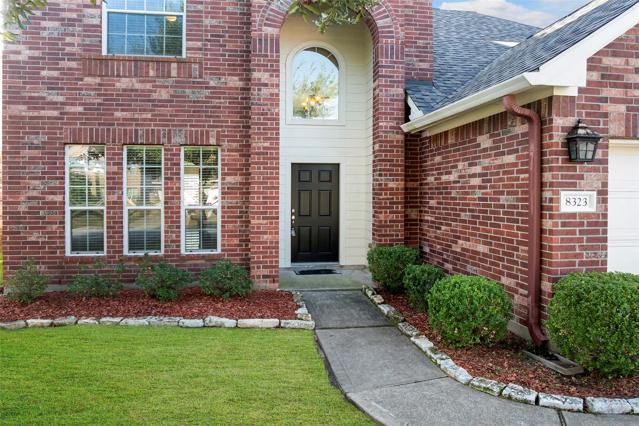 8323 Rudy Brook Way Spring, TX 77379 - Photo 3 of 35 a front view of a house with a garden