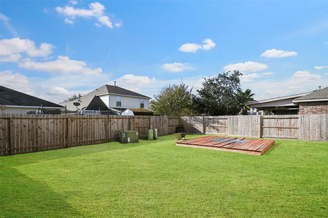 a backyard of a house with table and chairs