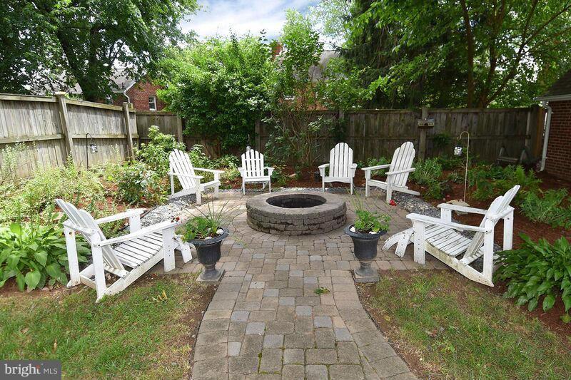 306 Indian Spring Drive Silver Spring, MD 20901 - Photo 28 of 30 a view of a patio with table and chairs potted plants and large tree