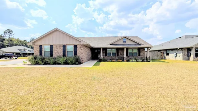 a front view of a house with swimming pool and porch with furniture