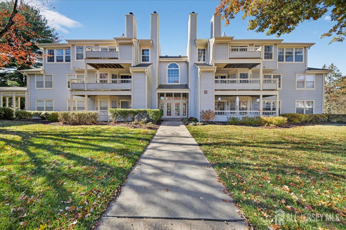 a front view of building with yard