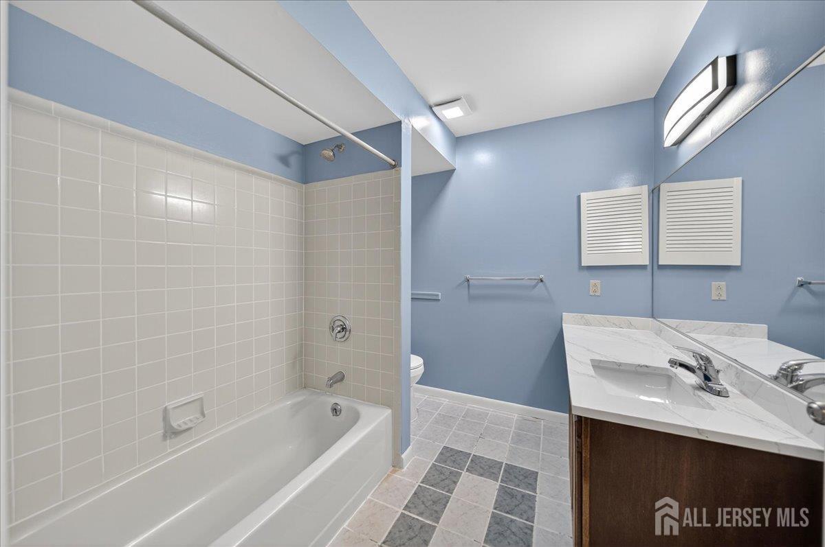 306 Trinity Court, Unit 12 Princeton, NJ 08540 - Photo 11 of 26 a bathroom with a sink a toilet and shower