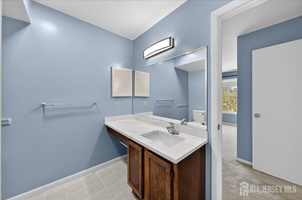 306 Trinity Court, Unit 12 Princeton, NJ 08540 - Photo 12 of 26 a bathroom with a sink and a mirror