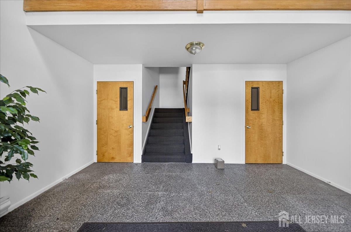 306 Trinity Court, Unit 12 Princeton, NJ 08540 - Photo 19 of 26 a view of a hallway with wooden floor and a potted plant