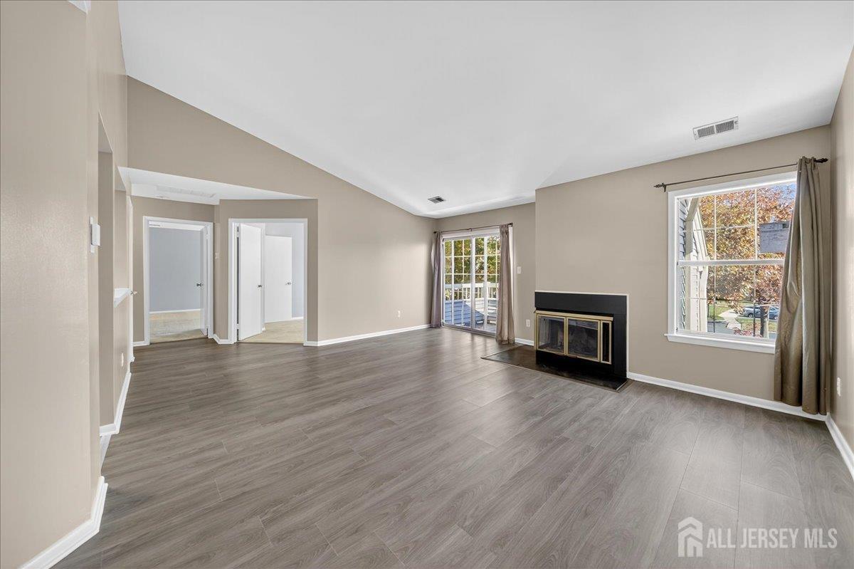 306 Trinity Court, Unit 12 Princeton, NJ 08540 - Photo 2 of 26 a view of empty room with fireplace and wooden floor